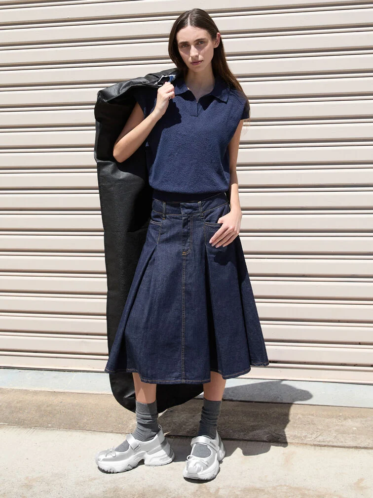 A casual top and midi skirt ensemble paired with chunky Mary Jane sneakers and socks