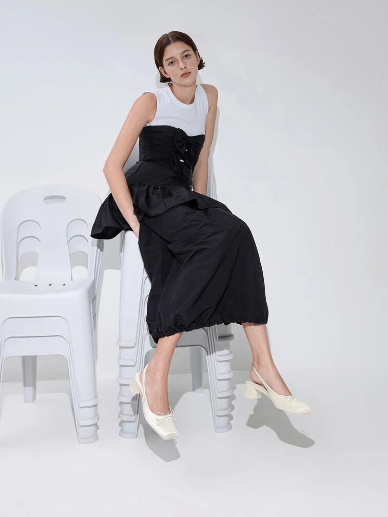 Anchor a dress with a voluminous skirt with chunky block heels to create a visually balanced look.