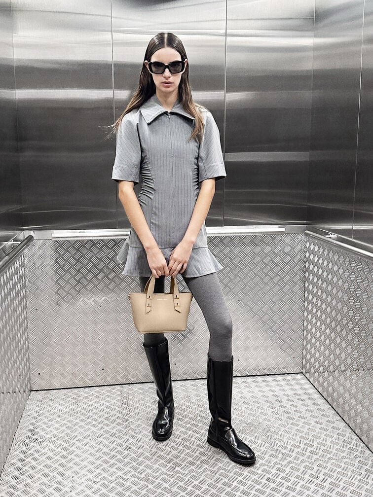 Round-toe knee-high boots pair well with a miniskirt and tights for a stylish preppy look.