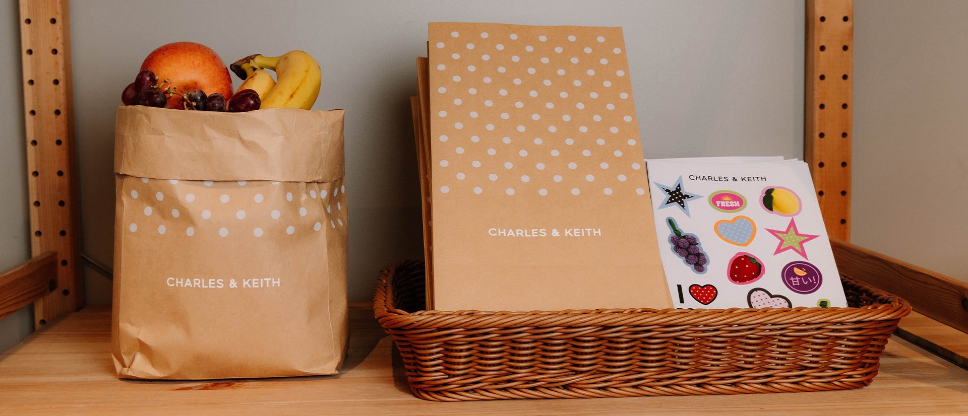 An aesthetic shot of CHARLES & KEITH Kraft paper bags and stickers
