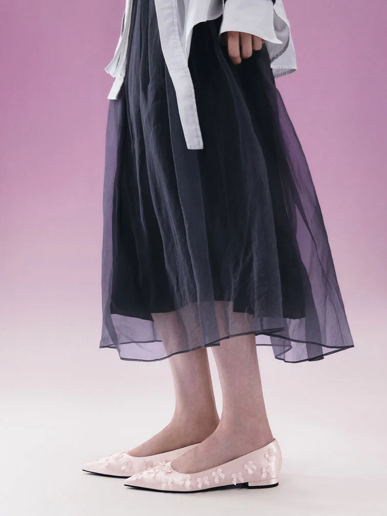 Gauze skirt styled with pink pointed-toe flats. 