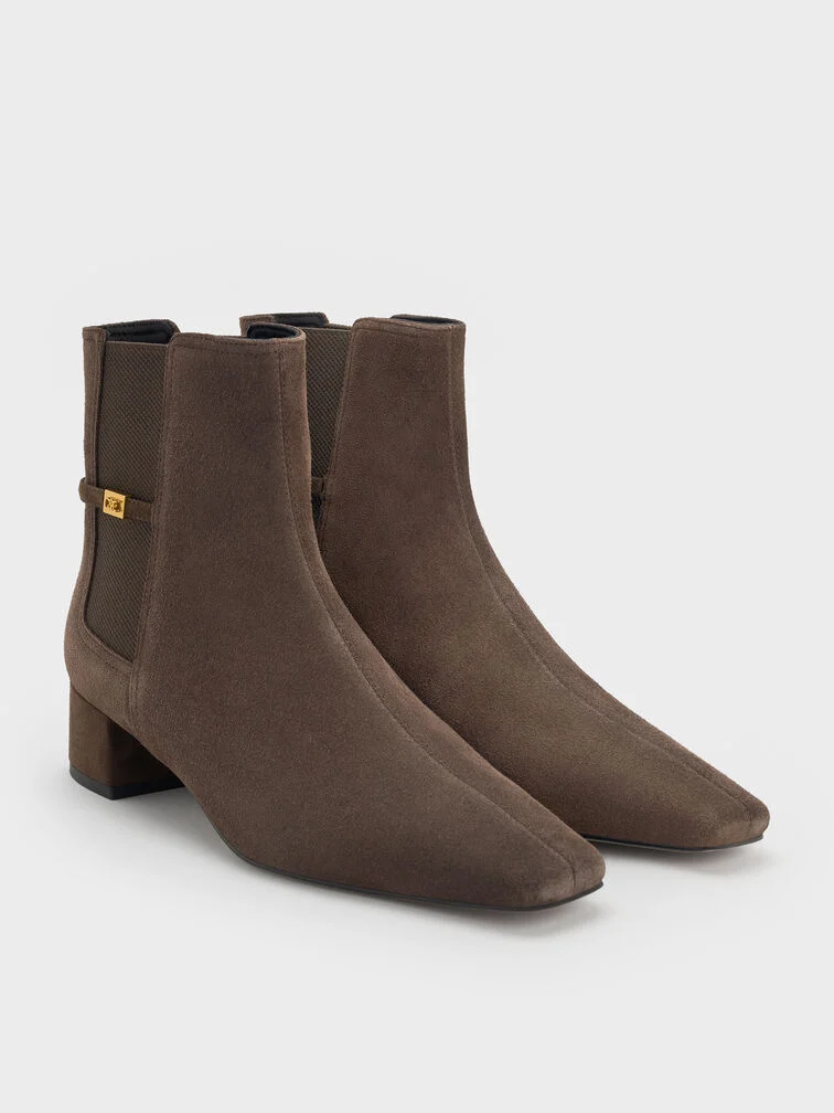 Cool-toned brown ankle boots with a tapered silhouette.