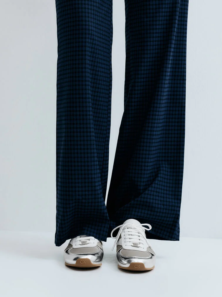  Balance the shine of metallic low-profile sneakers with softly draped wide-leg trousers in a subtle check print to create a bold but tasteful combination. 