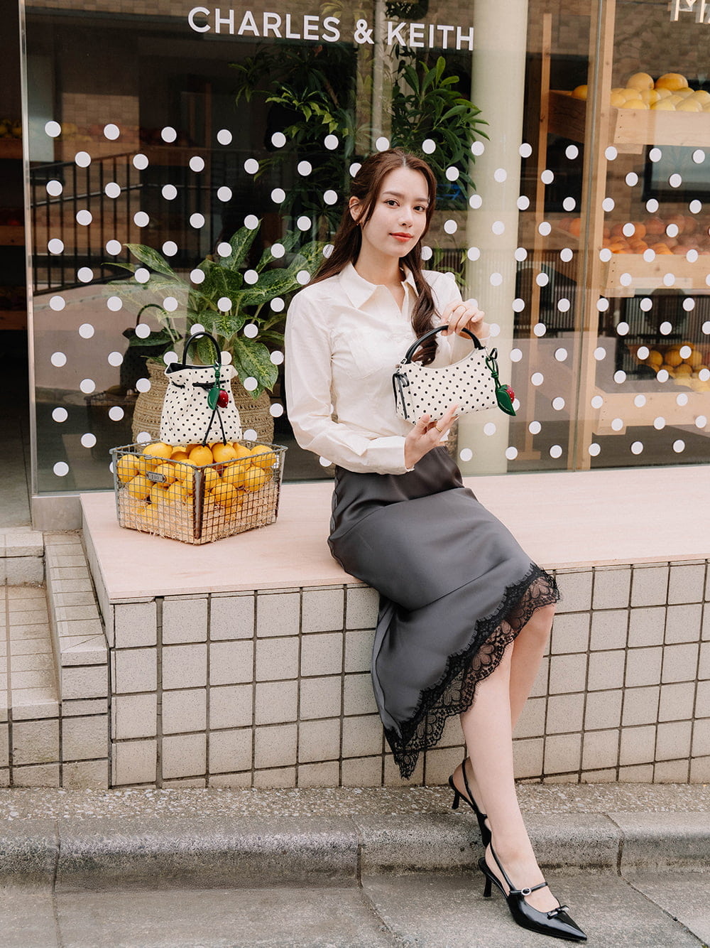 Hazel Bow Polka-Dot Top Handle Bag in cream and Sonali bow slingback pumps in black - CHARLES & KEITH