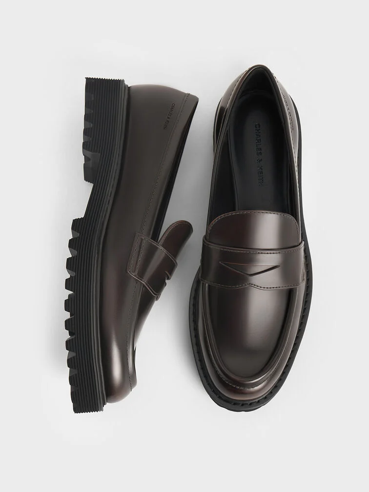 Dark brown loafers with slightly pointed almond toes.
