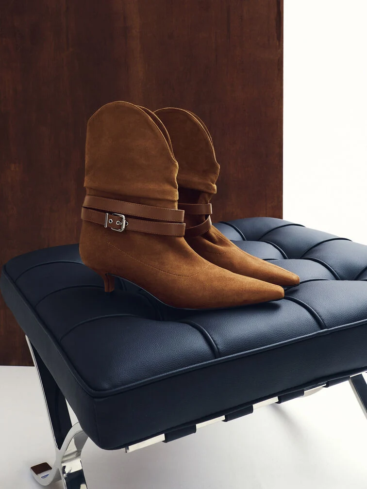 Brown boots with pointed square toes and kitten heels.