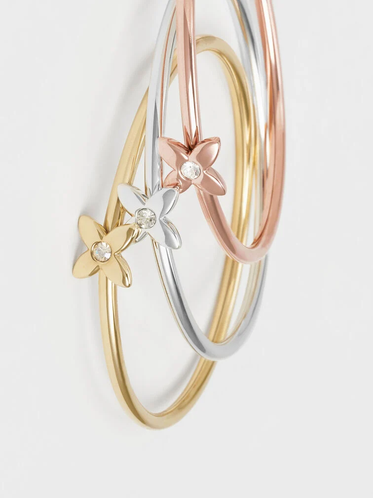 Gold, rose gold and silver flower-motif crystal bangle, a timeless and sentimental gift to give your mum this Christmas. 