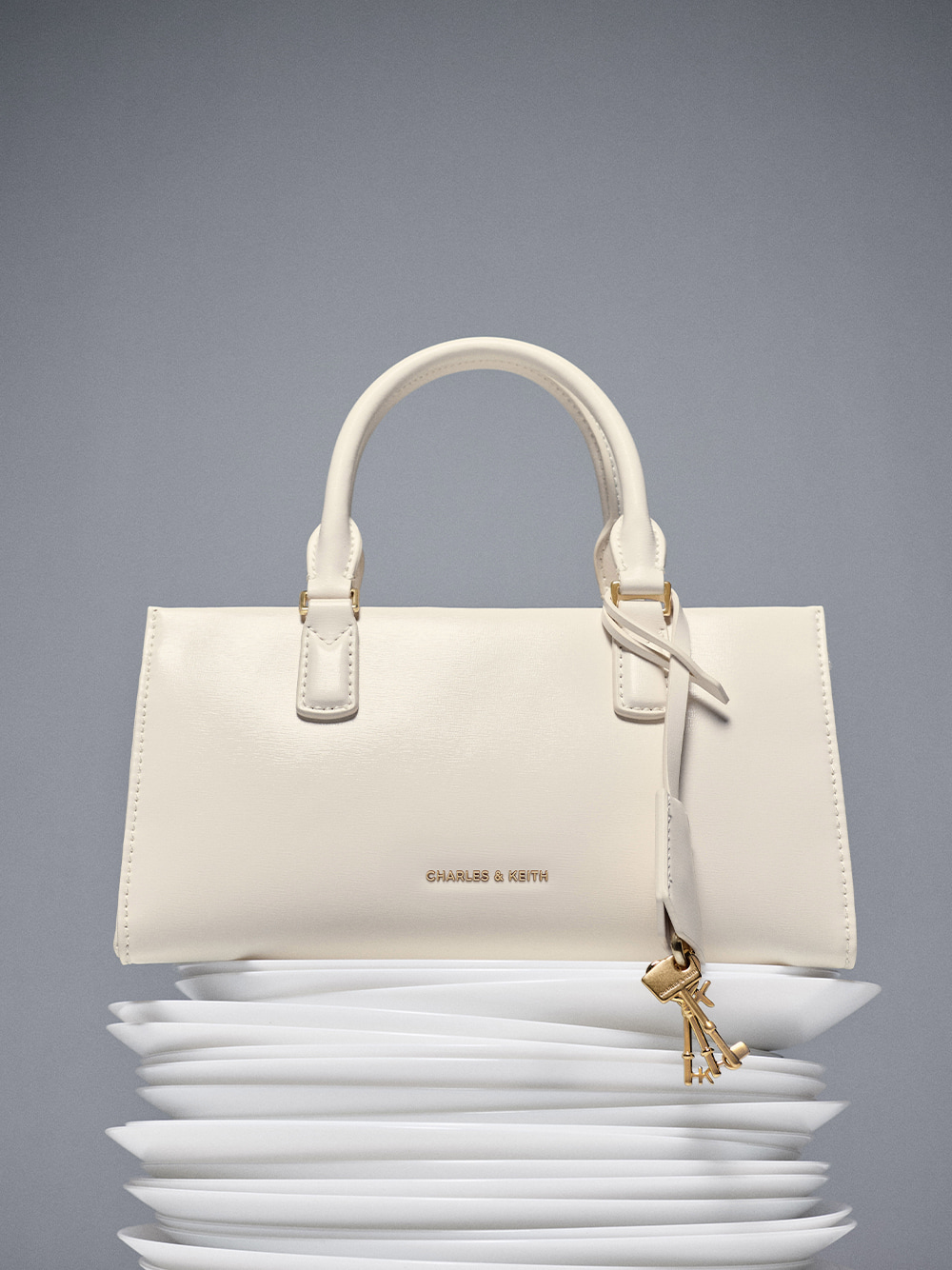 Mini Kerry top handle bag in cream - CHARLES & KEITH