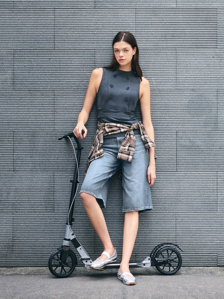 Sleek Mary Jane sneakers complete a casual denim jorts and top ensemble.