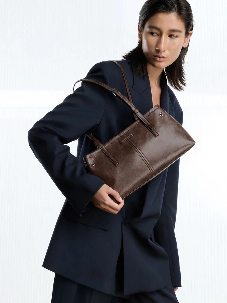 Minimalist East-West bag with a distressed coffee finish.