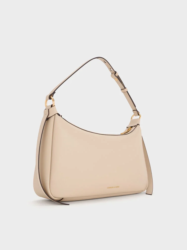 The shoulder bag is very similar to an East-West bag but with a shorter strap.