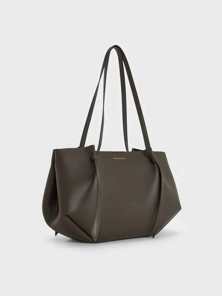 Moss-green tote bag with a softly structured geometric shape.