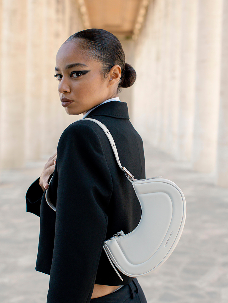 Women’s Petra curved shoulder bag and Pixie platform mules in white, as seen on Mikaela Neaze Silva – CHARLES & KEITH