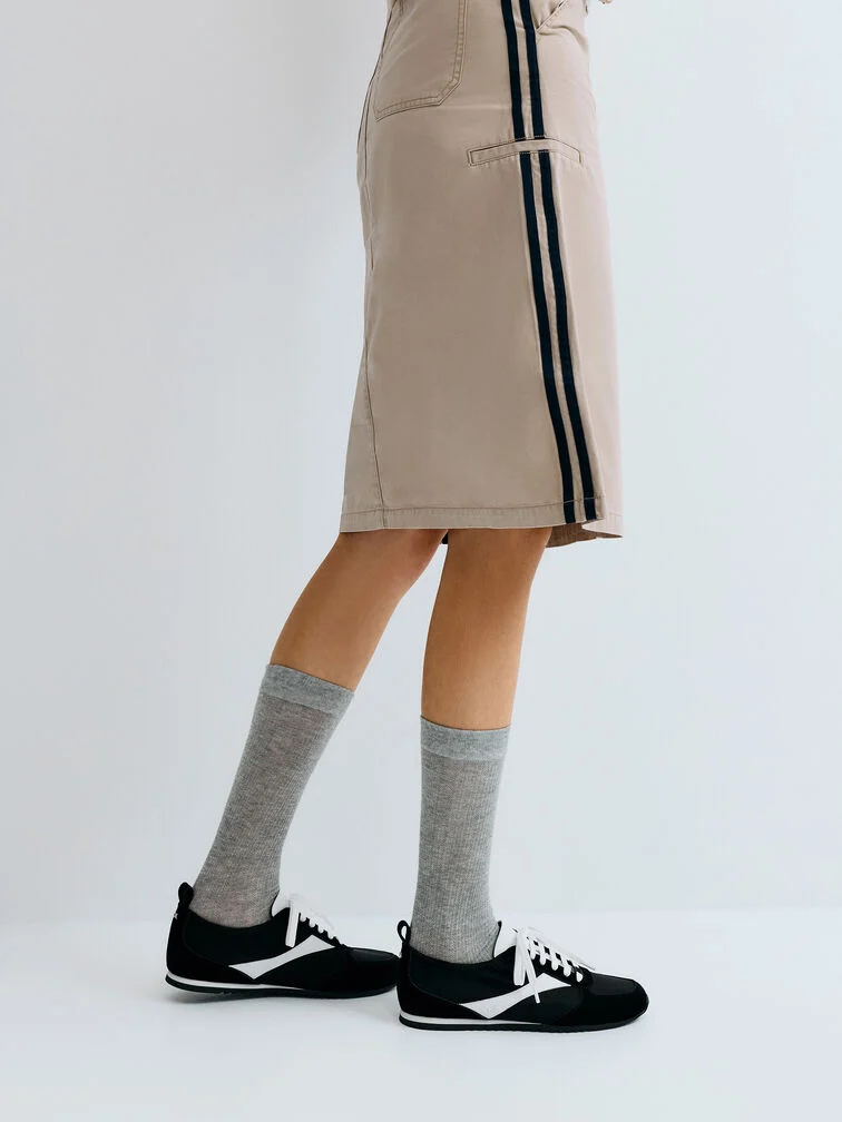  Low-profile sneakers are a practical and stylish choice for any race day.