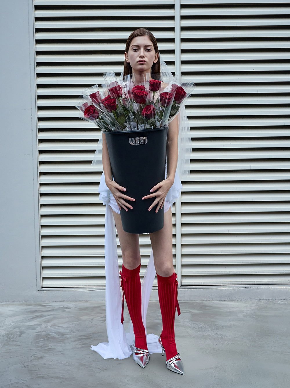 Silver Jessy bow slingback pumps styled with contrasting red knee-high bow socks - CHARLES & KEITH